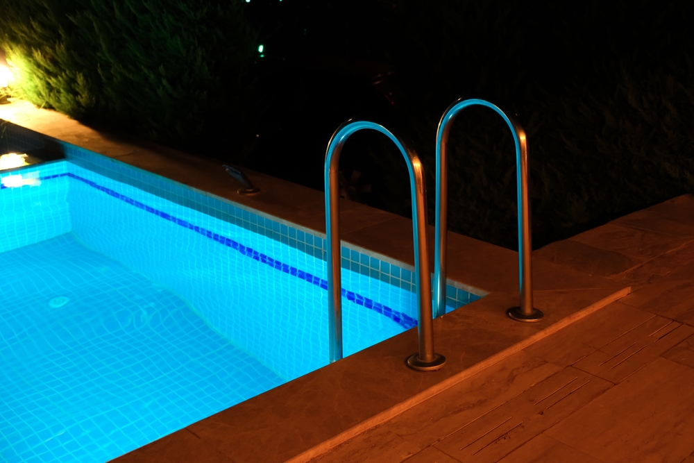 amenajare curte cu piscina iluminata noaptea