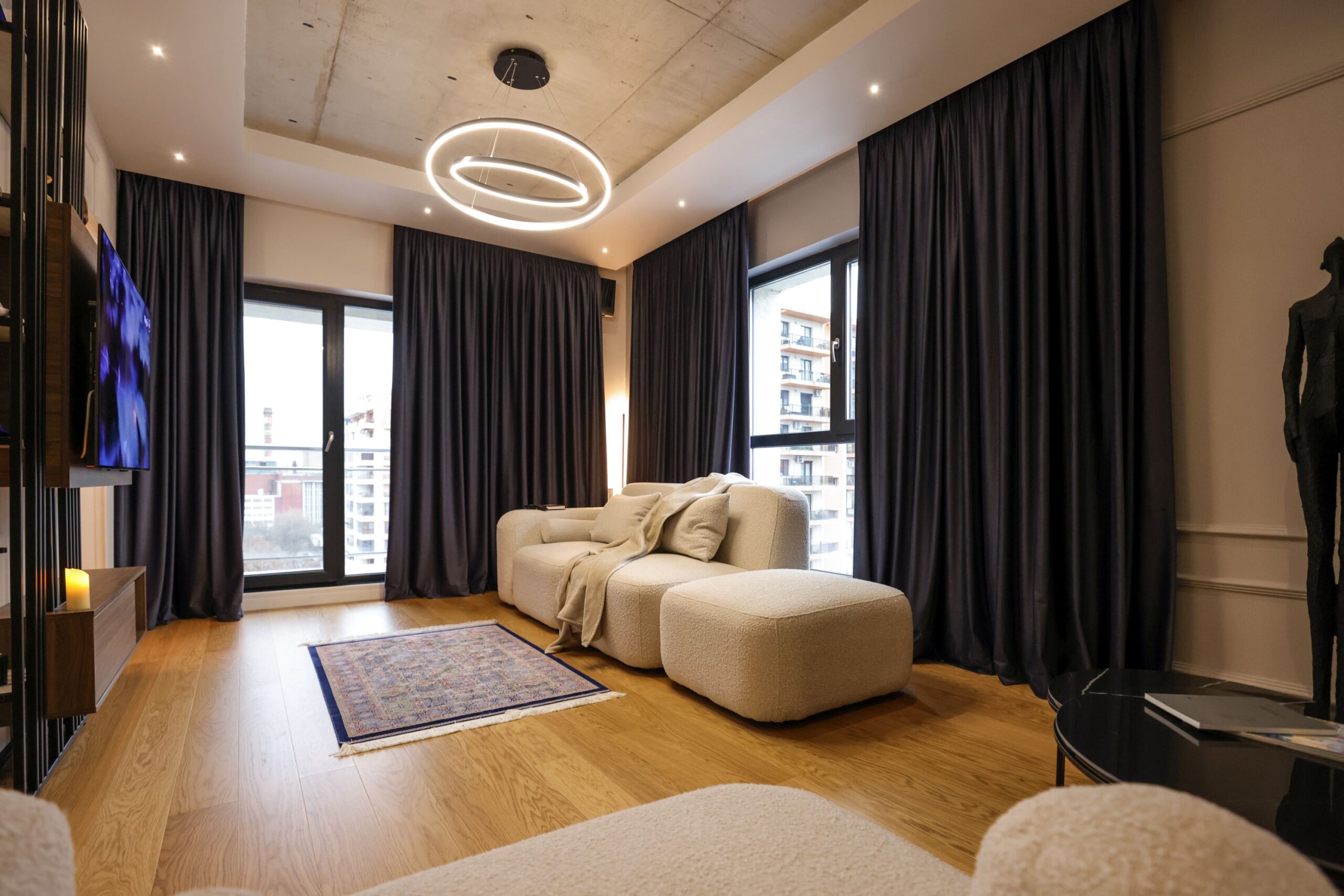 living apartament andra marinescu canapea alba draperii bleumarin parchet din lemn tavan beton aparent stil industrial contemporan minimalist